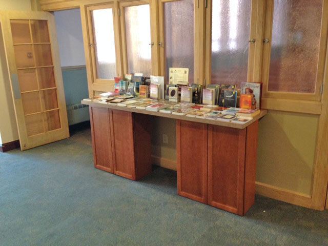 A temporary book table assembled from cabinets that will be installed in upstairs classrooms.